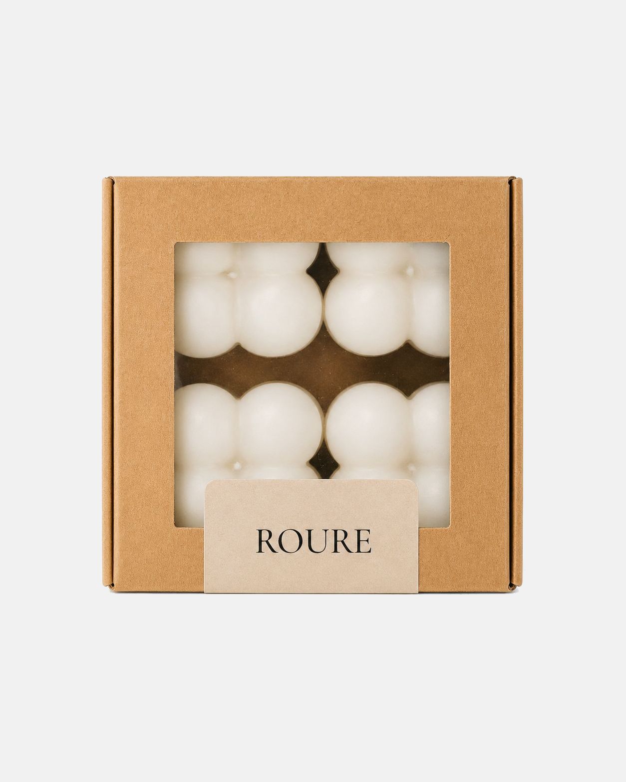 Box of white candles with 'ROURE' branding on a light gray background